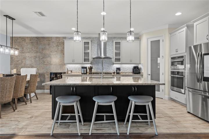 Stunning Kitchen with upgraded lighting fixtures, quartz back splash, 42