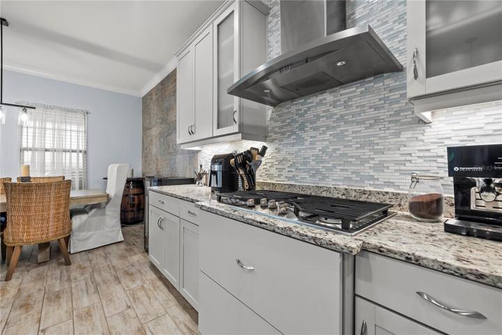 Stunning Kitchen with upgraded lighting fixtures, quartz back splash, 42