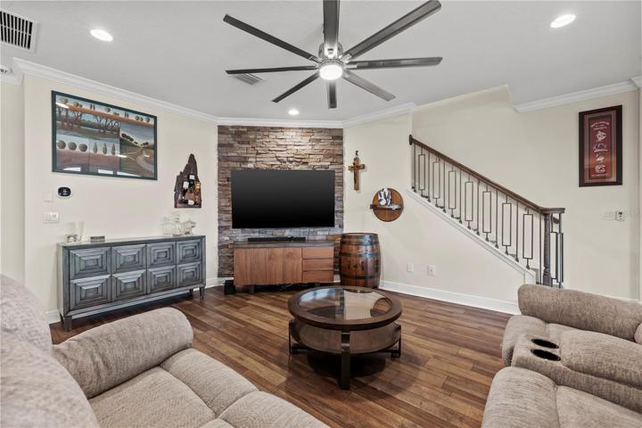 Family room with sliders to rear porch and community pool