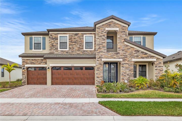Stunning front View of this gorgeous 5 bedroom 4 bath 3 car garage on a community lake