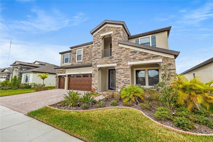 Stunning front View of this gorgeous 5 bedroom 4 bath 3 car garage on a community lake