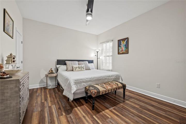 Downstairs Bedroom with walk in closet, attached bathroom and new luxury vinyl wood planks