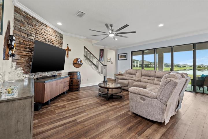 Family room with sliders to rear porch and community pool