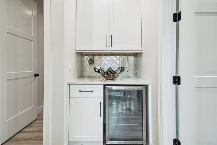 Level 3 built in beverage center and cabinets in hallway outside bedrooms.