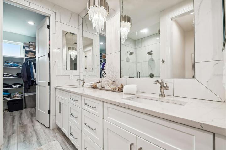 Primary bedroom walk-in closet, accessible from primary bathroom.