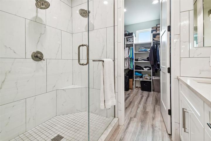 Dual shower heads in primary bathroom shower.