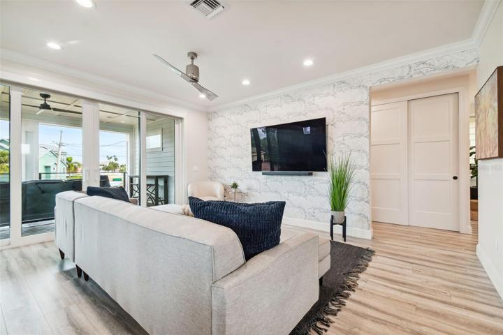 Family room with open floorplan to kitchen and sliding glass doors to lanai.