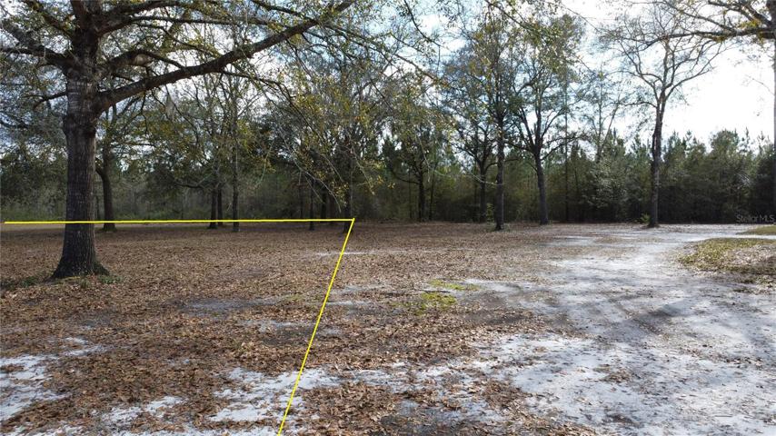 Standing by green electrical box facing South.  Front edge of lot.Property lines indicated are approximate and used for visual assistance only.