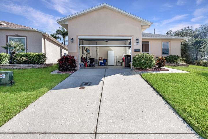 Front of property with automatic garage screen over 1.5-car garage
