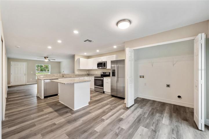 white shaker cabinets, granite counters, stainless steel appliances