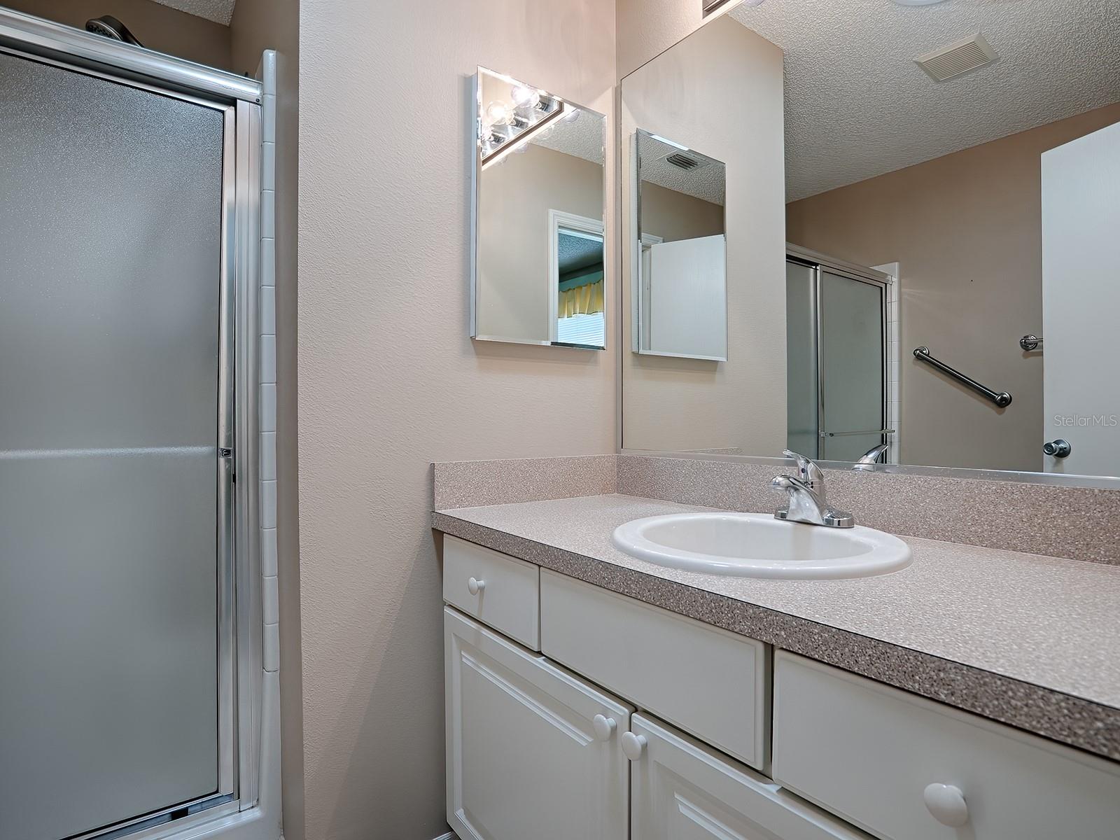 PRIMARY BATH WITH LAMINATE COUNTERS.