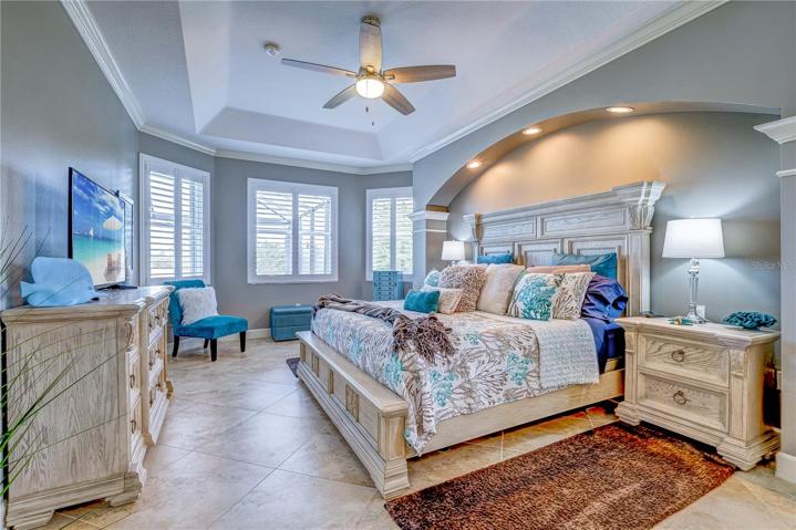 Owner's bedroom with beautiful windows and bed alcove.