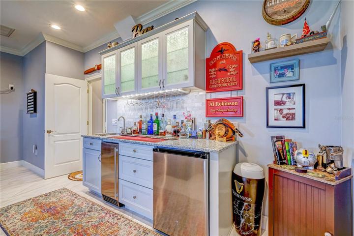 Bonus room kitchenette includes fridge, ice maker, sink, and cabinets!