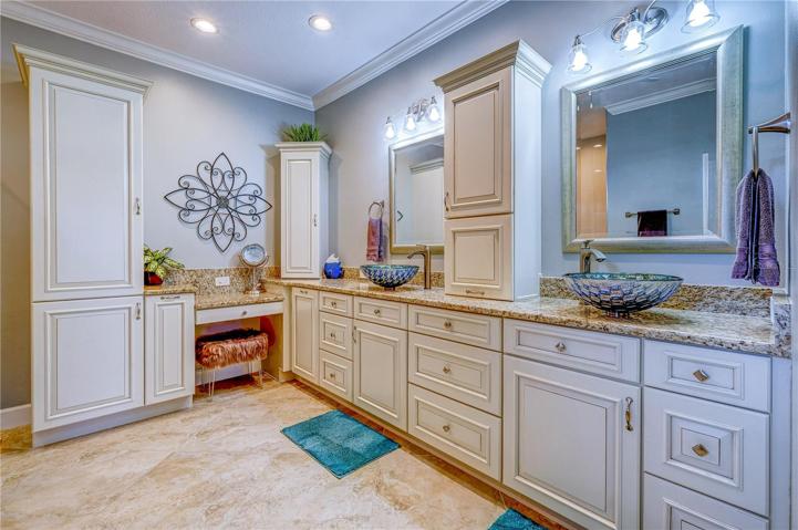 Owner's ensuite bathroom showing vessel sinks and expansive vanity with tons of storage!