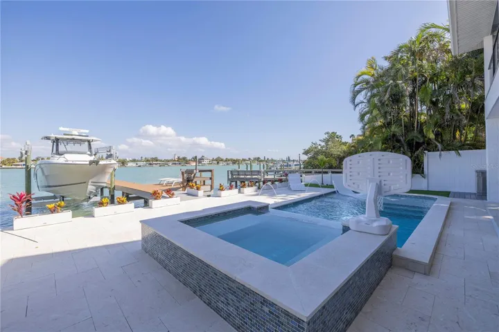 New Heated Pool & Spa with sunshelf and bar stools.
