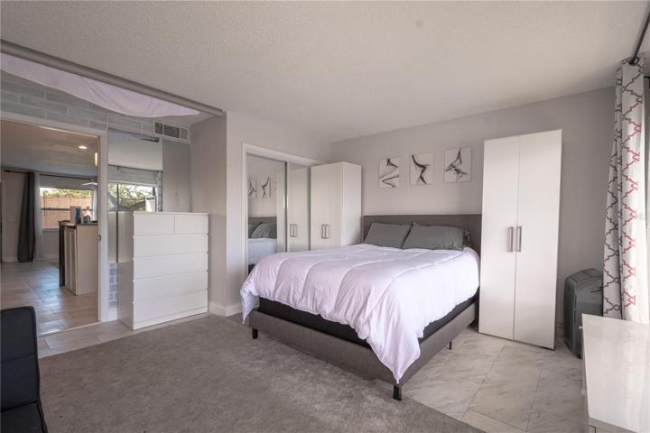 Neutral tones and built in closets round out the primary bedroom.