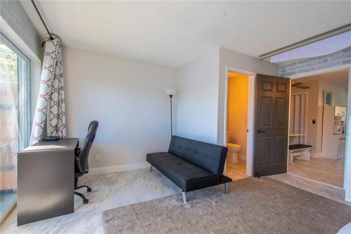 A spacious seating area  and half bath in primary bedroom.