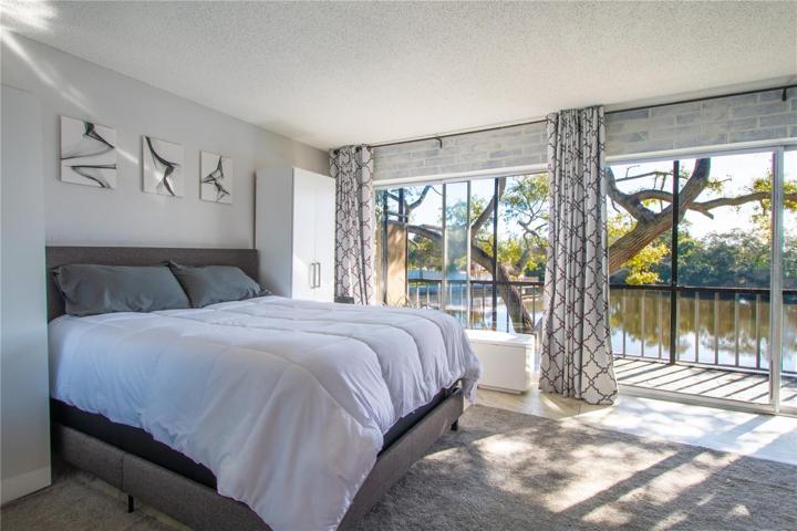 The primary bedroom has wall to wall sliding glass doors.