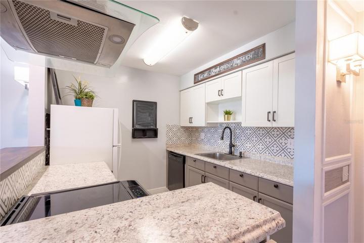 The kitchen comes equipped with a suite of appliances.