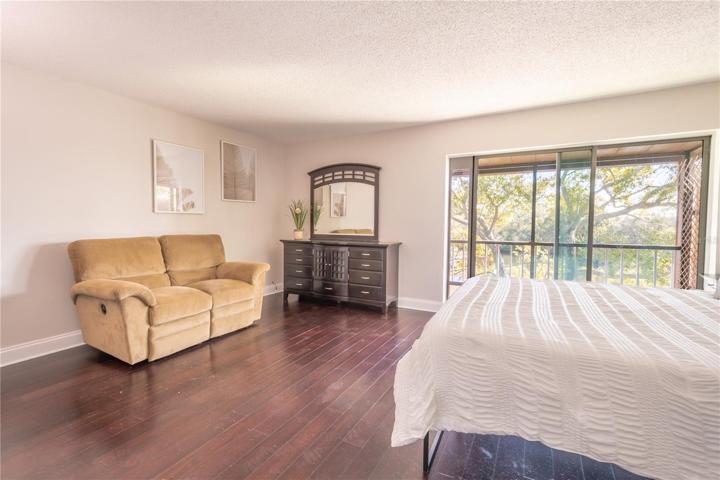 The 2nd bedroom features a neutral color palette and sliding glass doors.