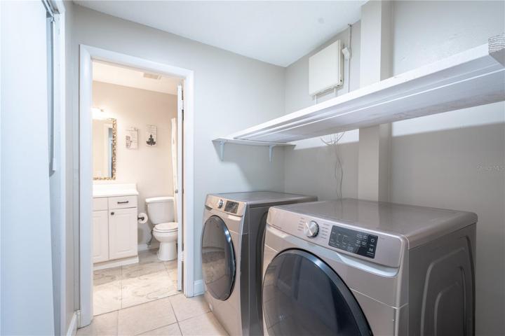 The laundry room has plenty of shelving and storage.