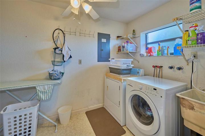 Laundry/storage room is located at the far side of the lanai