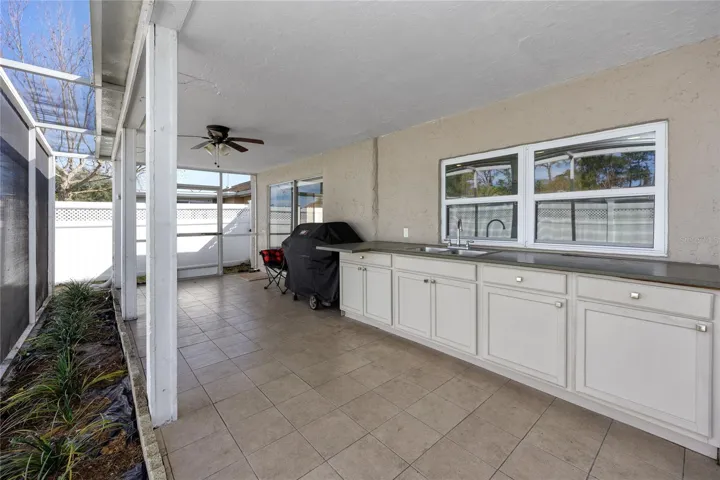 Screened in porch with outside kitchen.