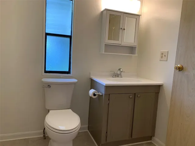 Primary bathroom with new cabinet, toilet, shower and flooring.