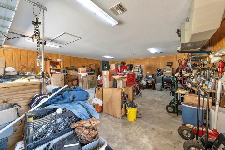 additional air conditioned 1,200 sqft detached garage (fit 6 cars total!) - that’s 1,640sqft of garage space total!! This second garage is a dream in itself – a paradise for hobbyists, car enthusiasts, or potential investors - as it is a 40’ x 30’ detached garage constructed of solid block (not wood frame) and ideal for a workshop, working on cars (deep enough for tandem parking) or opportunity for investment income by converting to a living space, as it has its own HVAC system, electrical breaker and account with FPL. Oversized parking pad on the attached garage for your bigger vehicles while having an additional parking pad (30’ x 27’) ideal for your toys or RV on the second detached garage.