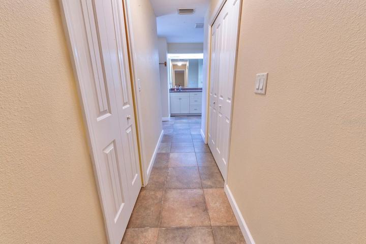 Hallway to master bath with large closets
