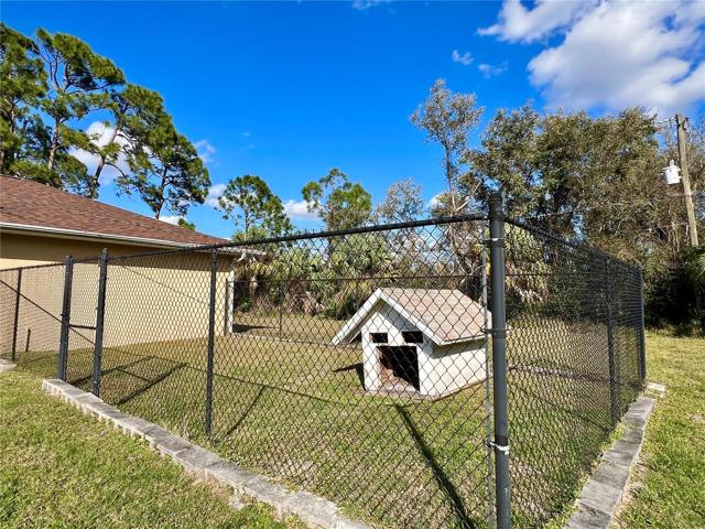 Fully fenced dog run with a dog house, also perfect for chickens