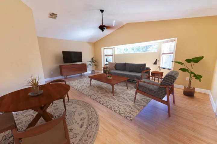 (Staged) Huge family/great room right off the kitchen with room for a dinette or pub table. Leads into the library/office/den