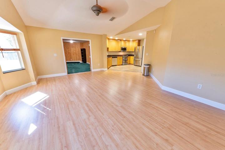 Huge family/great room right off the kitchen with room for a dinette or pub table. Leads into the library/office/den