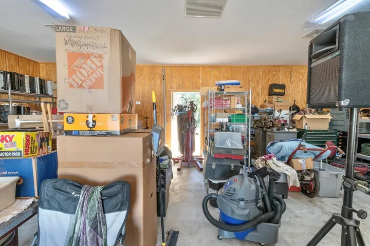 additional air conditioned 1,200 sqft detached garage (fit 6 cars total!) - that’s 1,640sqft of garage space total!! This second garage is a dream in itself – a paradise for hobbyists, car enthusiasts, or potential investors - as it is a 40’ x 30’ detached garage constructed of solid block (not wood frame) and ideal for a workshop, working on cars (deep enough for tandem parking) or opportunity for investment income by converting to a living space, as it has its own HVAC system, electrical breaker and account with FPL. Oversized parking pad on the attached garage for your bigger vehicles while having an additional parking pad (30’ x 27’) ideal for your toys or RV on the second detached garage.