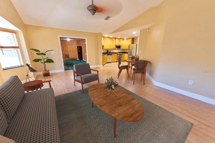 (Staged) Huge family/great room right off the kitchen with room for a dinette or pub table. Leads into the library/office/den