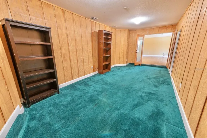Porch professionally converted into a living space for a library, den, office, play room or workout room