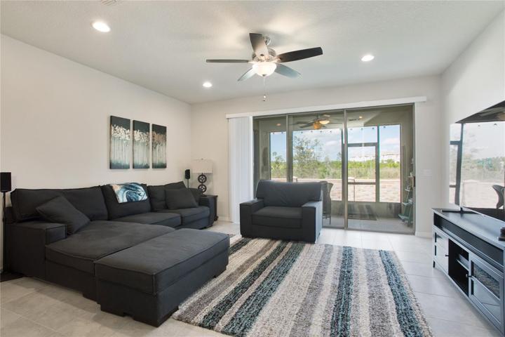 TRIPLE SLIDING GLASS doors deliver an abundance of natural light and access to the SCREENED LANAI!