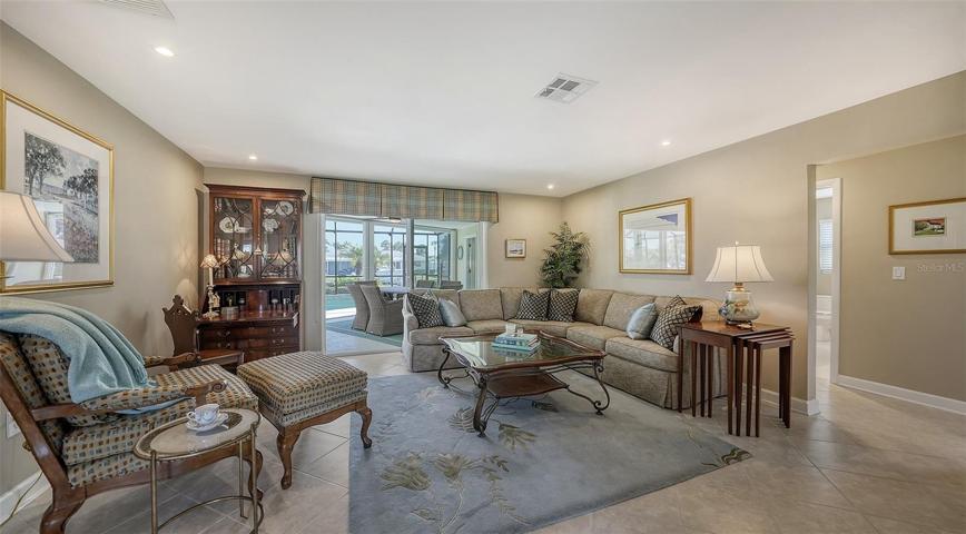 The relaxing great room opens up to the covered terraces & pool