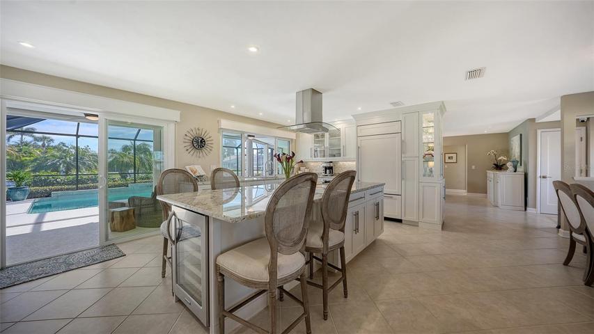 Your company can enjoy appetizers around the custom granite island