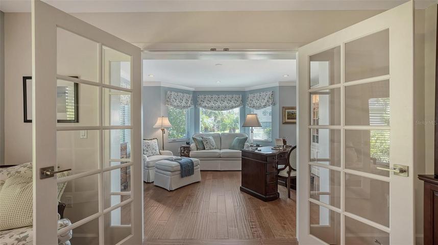 Custom french doors separate the bedroom from the Owners' library
