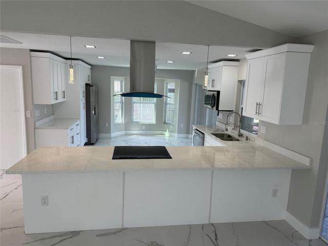 Updated kitchen with quartz counters and wood cabinets