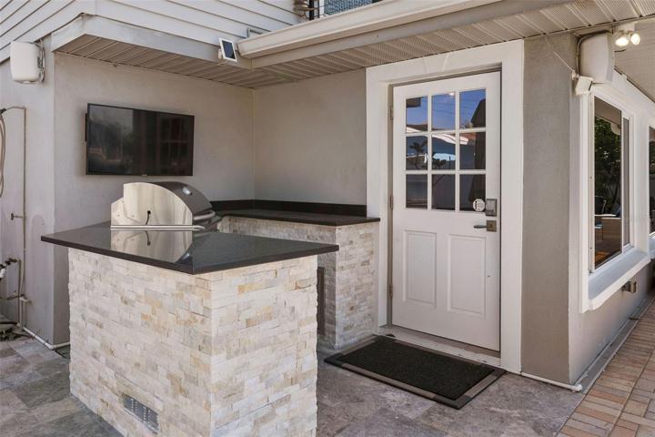 Outdoor kitchen with outdoor fridge bar and Television