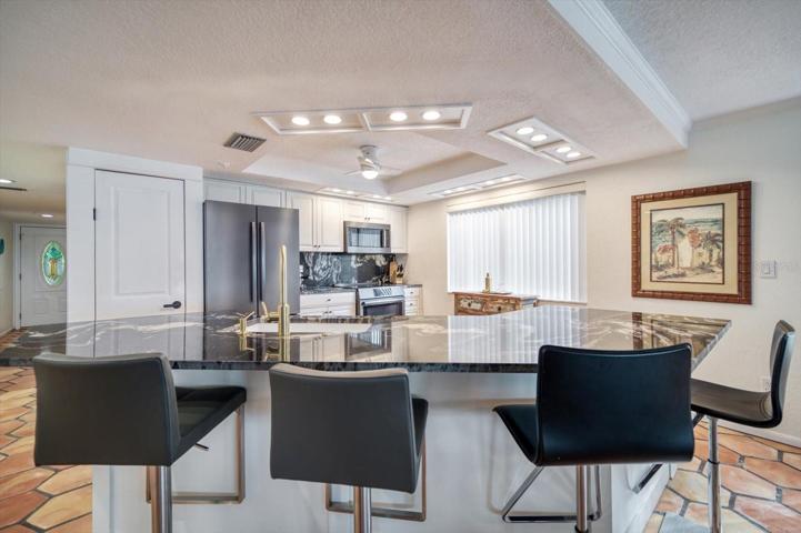 Kitchen with large breakfast bar has been recently remodeled.