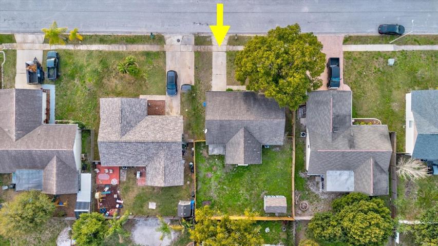 Aerial view looking down at the home and yard