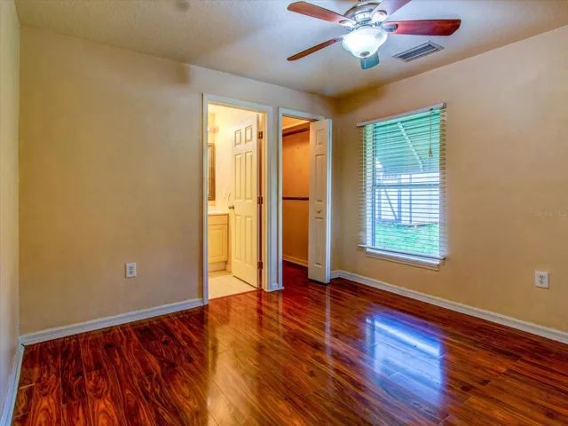 Primary Bedroom facing closet and Primary Bathroom