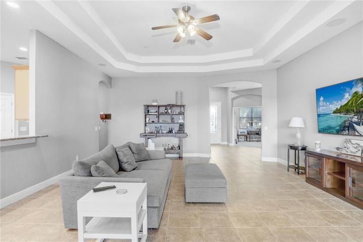 VIEW OF GREAT ROOM TOWARDS THE AREA OF THE ENTRANCE, DINING ROOM AND OFFICE - KITCHEN SHOWING ON THE LEFT AS WELL AS THE ENTRANCE TO A SMALL HALL LEADING TO THE GARAGE & INSIDE LAUNDRY AND WELL AS AN ADDITIOANL ENTRANCE TO THE KITCHEN