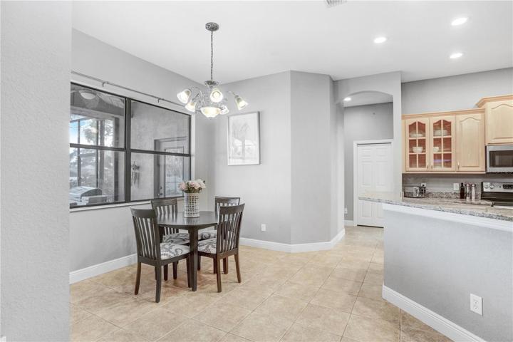 VIEW TO DINETTE : WINDOW HAS VIEW OF COVERED/SCREENED IN LANAI/POOL --  ENTRANCE WAY IN THE CENTER LEADS TO BEDROOMS 1 & 2, SHARED BATH & POOL BATH