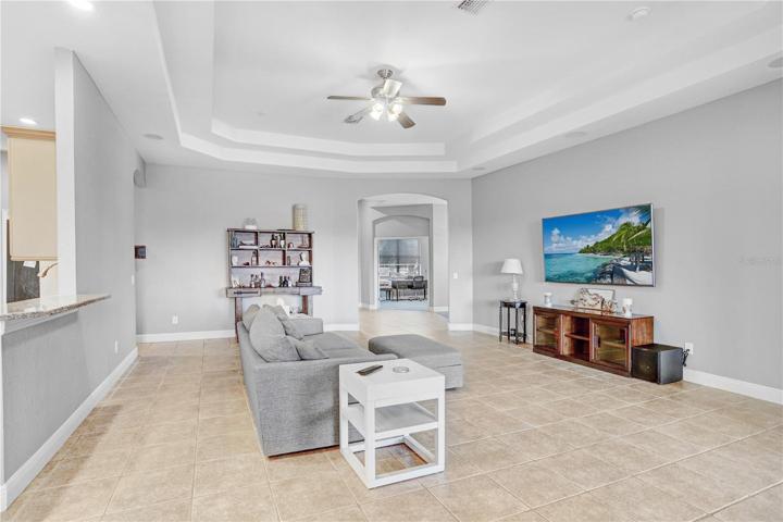 VIEW OF GREAT ROOM TOWARDS THE AREA OF THE ENTRANCE, DINING ROOM AND OFFICE - KITCHEN SHOWING ON THE LEFT AS WELL AS THE ENTRANCE TO A SMALL HALL LEADING TO THE GARAGE & INSIDE LAUNDRY AND WELL AS AN ADDITIOANL ENTRANCE TO THE KITCHEN