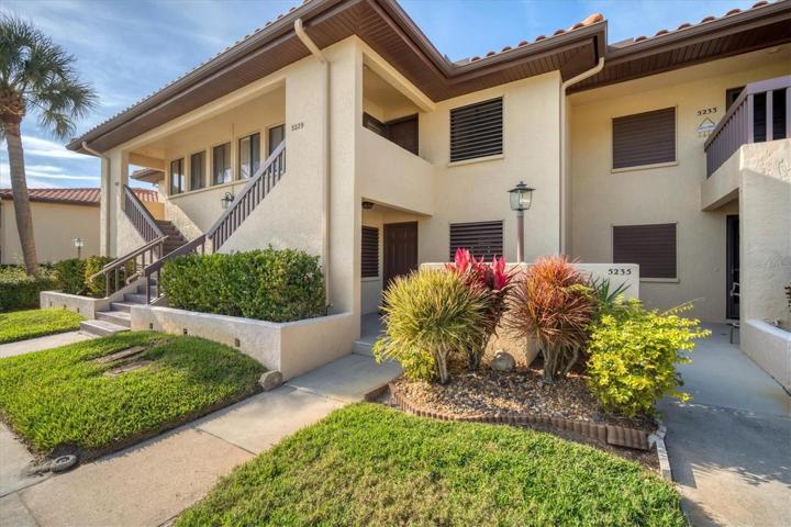 Exterior front door entryway with light and landscaping