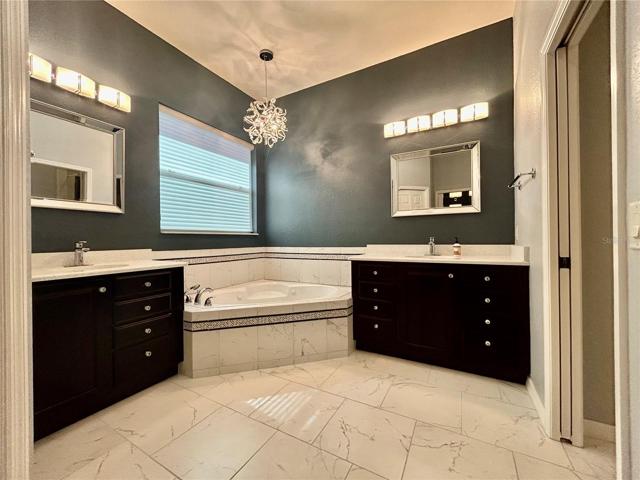 his/her vanity with jetted soaking tub